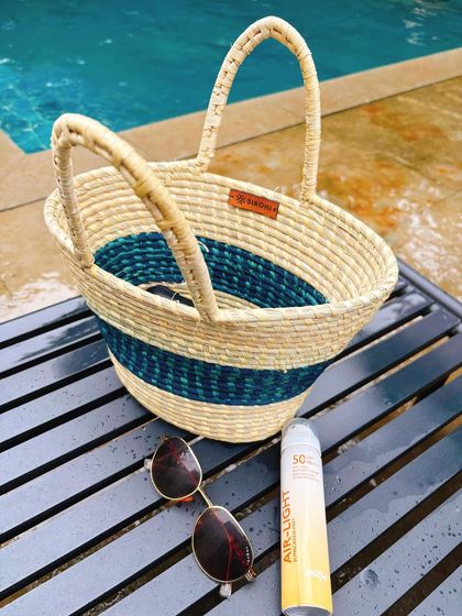 My summer essentials. This flat lay features a handmade beach bag, sunglasses, and my go to spray on sunscreen. It's a great way to recommend products in a visually appealing format.