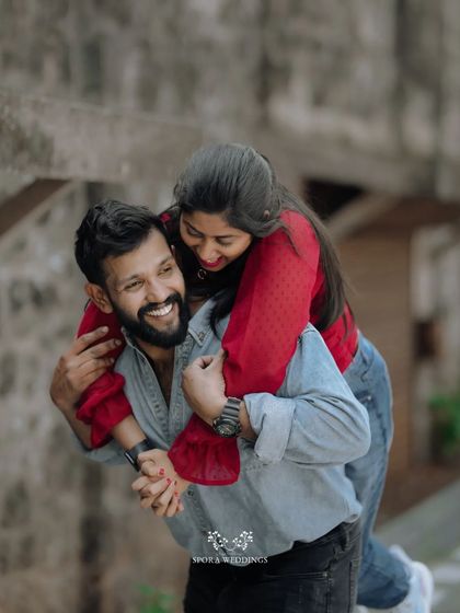 A joyful piggyback moment, the couple's laughter making this a heartwarming and candid shot.