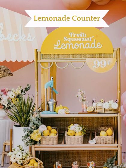 A charming and rustic Lemonade Counter. This is a perfect addition to a daytime summer wedding, offering a fresh and delightful treat for guests.