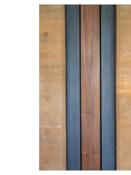 A detail of the material palette: rammed earth, steel, and salvaged wood. We believe that the quality of craft and the honesty of materials are what elevate a building into art.