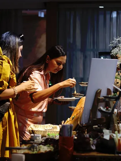 Guests enjoying our buffet, a candid moment showing people interacting with our food displays.