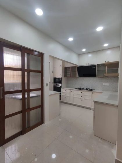 A duplicate of 76, showing the practical and stylish sliding door that connects the kitchen to another space.