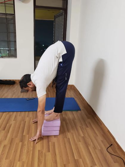 To improve forward folds, we use props like yoga blocks. Here, I demonstrate how stacking blocks can help you gradually increase your hamstring and lower back flexibility.