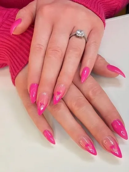 A dramatic look with hot pink "jelly" nails featuring subtle heart outlines embedded within the transparent color.