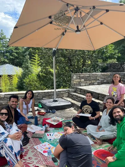 A relaxed, creative session outdoors in Bhutan. We believe in balancing deep spiritual work with moments of lighthearted connection and artistic expression.