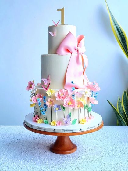 A full view of the floral bow cake in a beautiful setting.