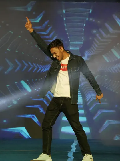 A student strikes a pose during his performance, showcasing the fun and dynamic atmosphere of our community events.