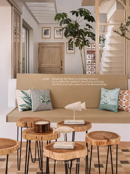 A waiting area from our House by the River project in Goa. The space is crafted for relaxed, slow living, with natural wood stools and fish sculptures that echo its calm surroundings.