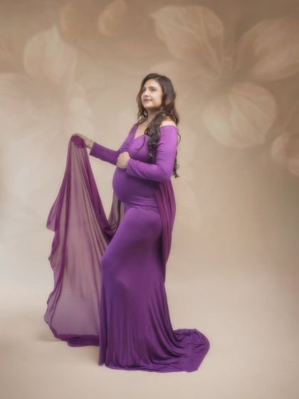 Radiant mama-to-be. This gorgeous purple gown highlights her elegance and grace, with the flowing fabrics and soft, golden light creating a breathtaking photo.