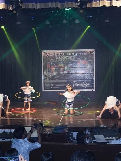 A creative formation using hula hoops, showing how we incorporate props to make performances fun and unique.