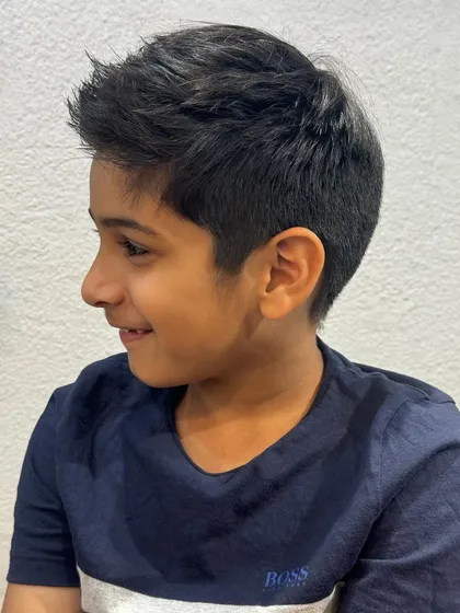 A smart and stylish haircut for this young man. It's a classic short style with a little bit of texture on top, perfect for school and play.