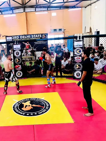 Two fighters squaring off at the 3rd Delhi State MMA Championship. This is the moment before the bell rings, a test of focus and strategy.