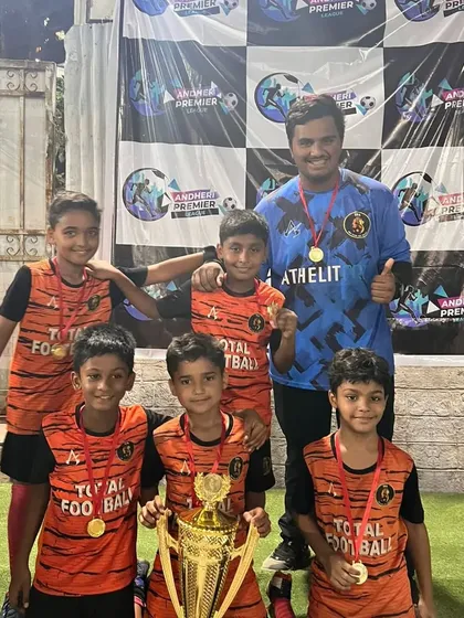 The U10 champions posing with their coach and trophy after winning their tournament at Andheri Sports Complex.