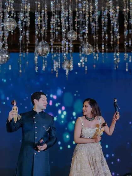 A fun and playful moment on stage with the couple holding Barbie and Ken dolls. We love incorporating personal, quirky details that make your event uniquely yours.