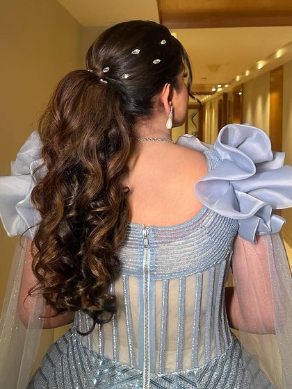 A detailed shot of the chic, embellished ponytail that adds a modern touch to this glamorous look.