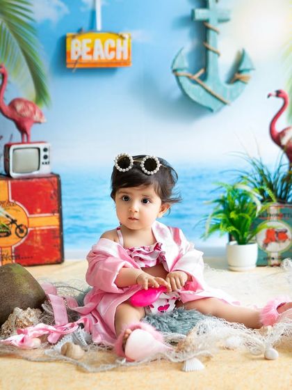 Lounging on the "sand" in my studio. The beach-themed setup includes real sand, shells, and fun props to create an authentic feel.