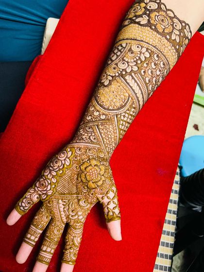 A beautiful non-bridal Indian design with full coverage on one arm. The patterns are a mix of floral and traditional motifs.