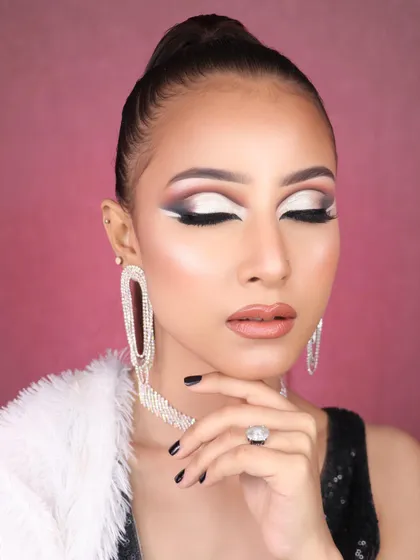 Feast your eyes on this stunning creativity. A dramatic graphic liner look with a silver cut crease and a high ponytail, perfect for a fashion editorial.