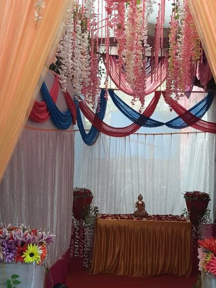 A beautiful entrance view for an engagement event, showing a mix of drapes and floral arrangements.
