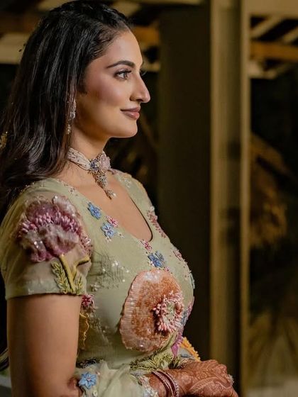 A side profile of bride Shree in her pastel Rahul Mishra lehenga. The delicate 3D floral embroidery is a signature of the designer and looks beautiful on her.