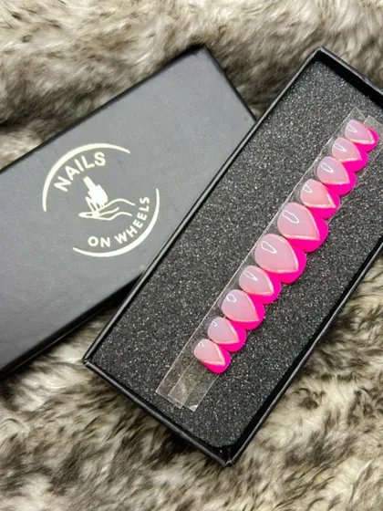 A vibrant twist on the classic French manicure. This set features a sheer base with bold, hot pink V-shaped tips, perfect for anyone who loves bright colors and modern nail designs.