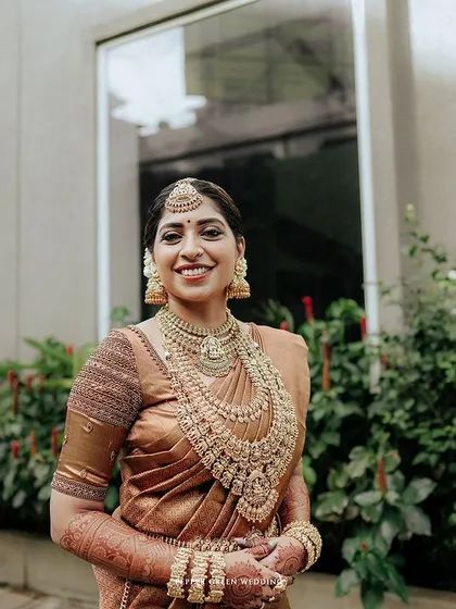 A lovely portrait of the bride, her smile warm and genuine, her traditional jewelry shining.