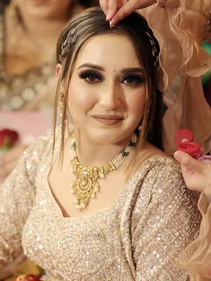 A candid moment during the bride's getting ready session, as petals are showered on her. It captures the joy and blessings of the women around her.