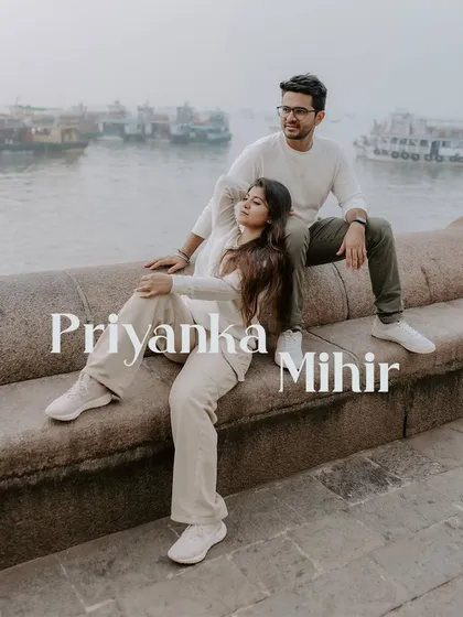 A relaxed and stylish pre-wedding portrait of a couple by the Mumbai harbor, showcasing a casual yet intimate moment.