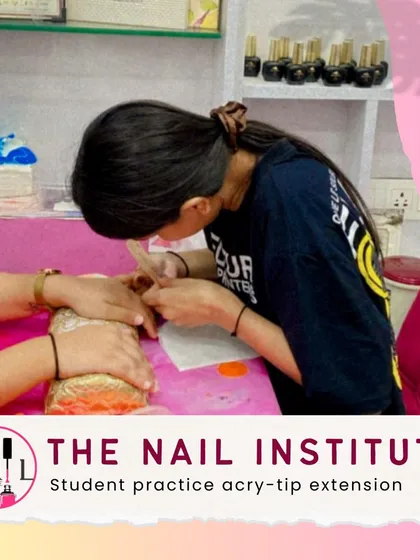 This student is practicing with acry-tips, an essential part of learning to create long and durable nail extensions.