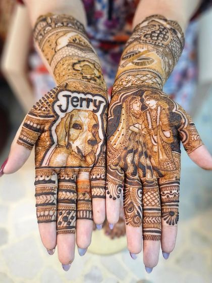 A full view of the custom bridal mehndi, showing the pet portrait on one hand and a couple portrait on the other. This is the ultimate example of a personalized design.