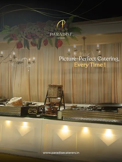 Picture-perfect catering, every time. An elegant buffet counter with a chandelier overhead, showcasing our attention to detail in creating a sophisticated ambiance.