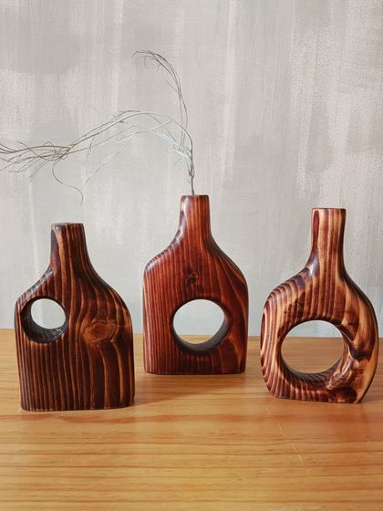 A trio of our hand-carved wooden vases, each with a slightly different shape and grain pattern. Together, they create a beautiful, cohesive decor statement.