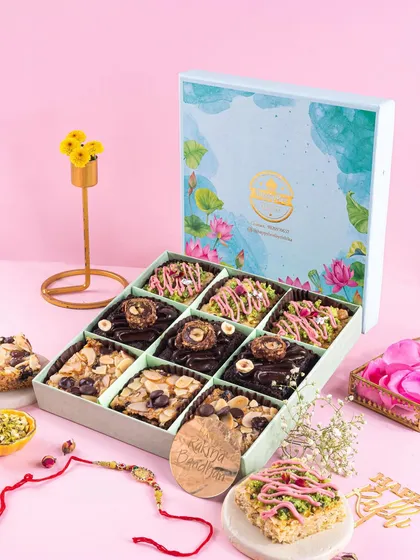 Showcasing a full Rakhi hamper with an assortment of brownies. The shot is styled to show both the beautiful packaging and the delicious contents, making it highly appealing for gifting.