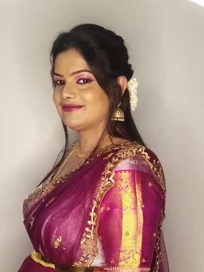 A smiling portrait of Kalyani, ready for the wedding festivities. The makeup is glamorous yet elegant.