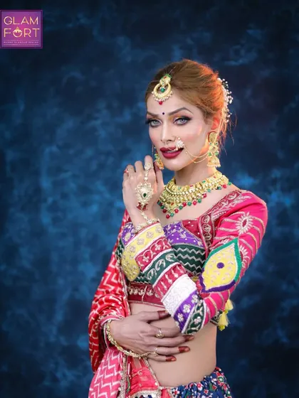 A confident pose in our festive Navratri attire. The makeup features a sharp winged liner and a bold red lip, perfect for dancing the night away.