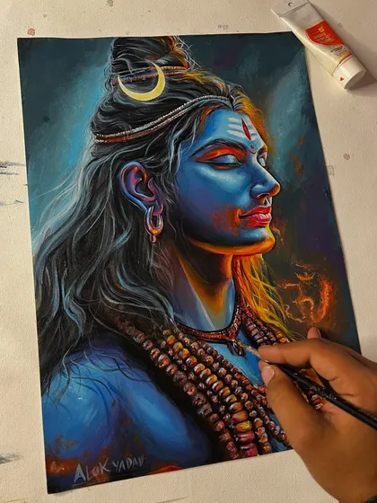 Here I am adding the final touches to my Mahadev painting. The use of a fine brush helps create the glowing embers and intricate details on his rudraksha beads.