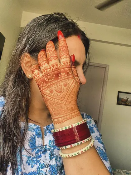 A client showing off the gorgeous, deep orange stain of her Karvachauth mehndi. This is the beautiful color you can expect as the henna matures.