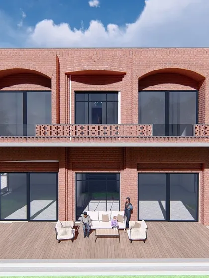Another angle of the farmhouse design, showcasing the two-story brick structure with a second-floor balcony. The use of traditional brick jaali work on the railing adds a decorative, contextual element.