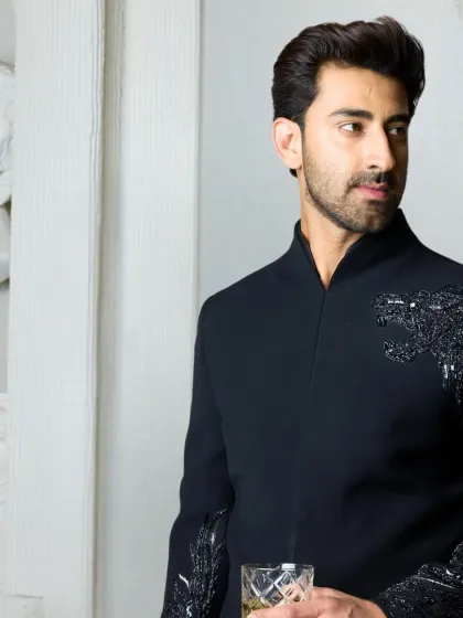 For the man who seeks the extraordinary, this black bandhgala features a hand-embroidered cheetah motif across the shoulder. It is a testament to exquisite Indian craftsmanship, symbolizing grace and power for life's unforgettable moments.