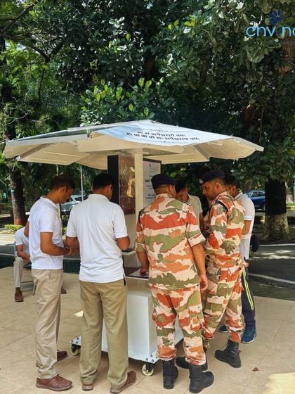 ITBP personnel gather around our solar patio unit during a showcase at their Dehradun camp. The demonstration highlighted features like device charging, lighting, and sheltered seating.