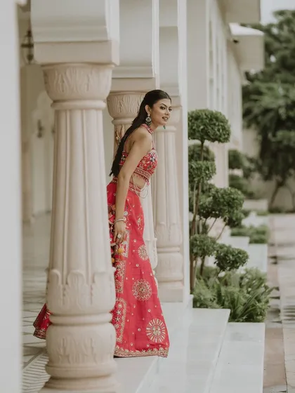 A candid moment captured during a Mehendi ceremony. Our pink lehenga is designed to look beautiful from every angle, whether you're posing or just enjoying your day.