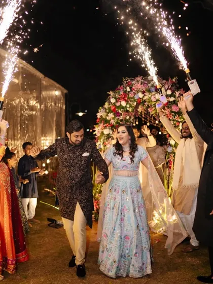 Capturing the pure joy of the celebration is what we do best. Here, the happy couple makes a grand entrance to their Sangeet, surrounded by friends, family, and a shower of sparklers, kicking off a night of music and dance.