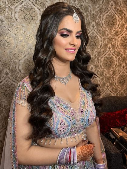 The side profile of this glowing goddess look. The soft waves in her hair and the perfectly blended pink eyeshadow create a romantic and modern feel.