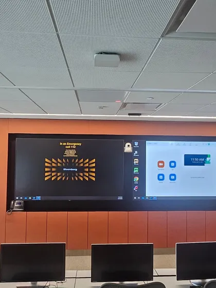 In this Mumbai office, I installed orange fabric-wrapped acoustic panels around the main video conferencing screen. This improves audio clarity for meetings by absorbing sound within the room.