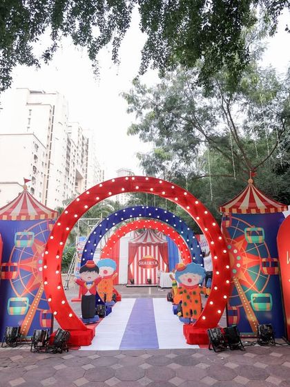 A beautiful outdoor shot of the carnival entrance, showing how the setup looks in a community space with natural greenery in the background.