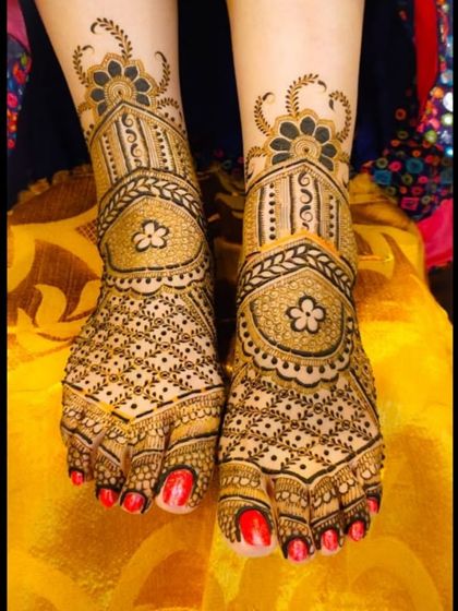 An elegant and symmetrical foot design, featuring delicate floral motifs and fine line work that beautifully adorns the feet.