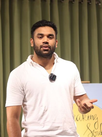 A performer passionately making a point during his storytelling set.