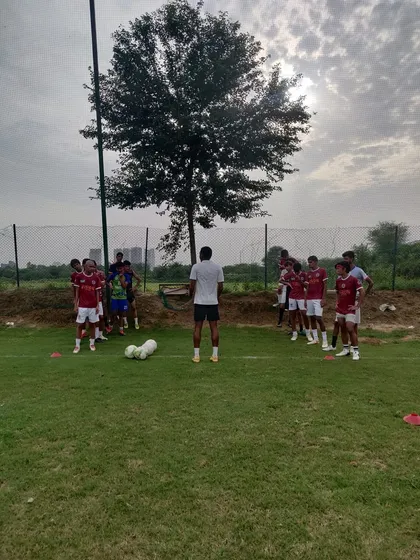A moment of instruction during a fitness session. Our coaches ensure proper form and technique to maximize results and prevent injuries.