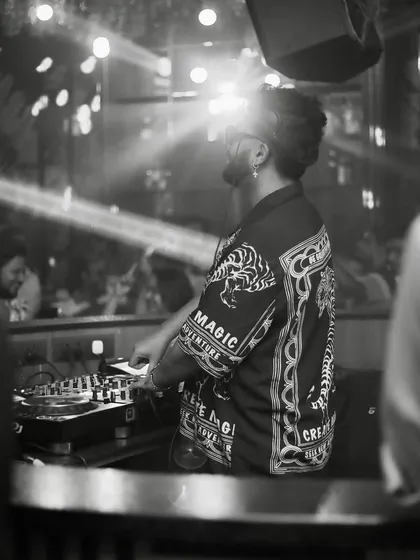 A moody black and white shot from behind the decks.