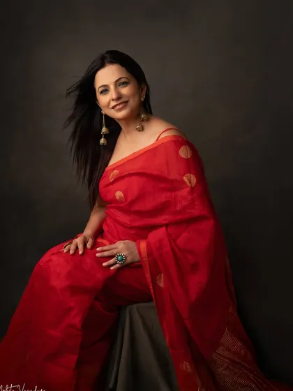 A woman in a red saree is a vision of grace and power. This portrait captures her elegance and the timeless beauty of this classic Indian attire.